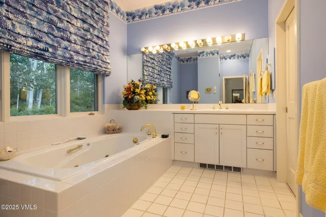 a bedroom with a bed and dresser with mirror