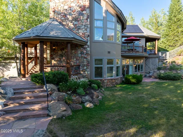 a living room with furniture fireplace and a large window