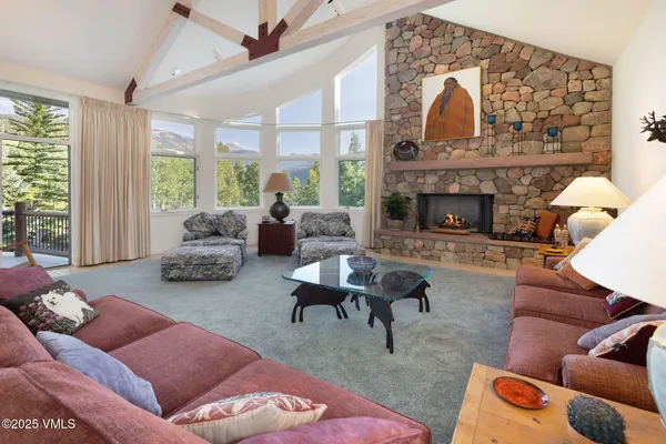 a living room with furniture ceiling fan and a large window