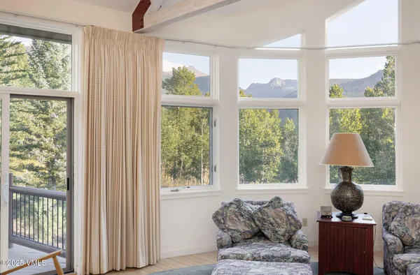 a kitchen with stainless steel appliances kitchen island granite countertop a table and chairs in it