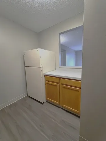 a view of a kitchen with a sink dishwasher and a refrigerator