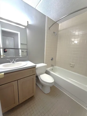 a bathroom with a double vanity sink toilet and shower