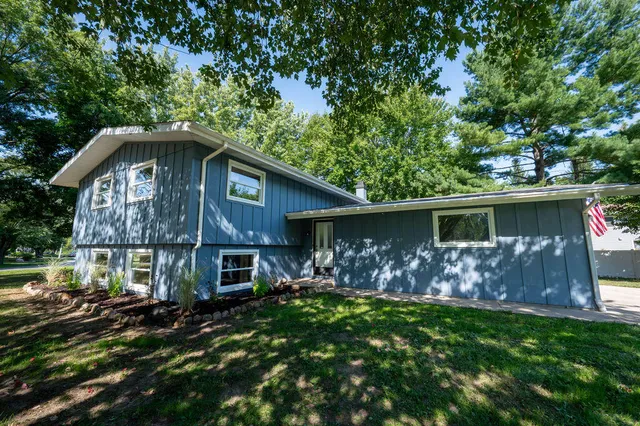 a front view of house with yard and green space