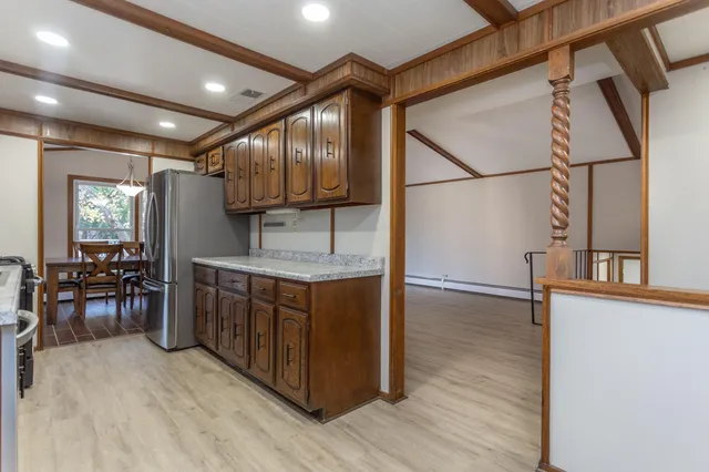 a kitchen with sink cabinets and wooden floor