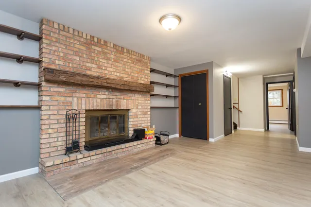 a view of an empty room with a fireplace