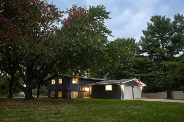 a view of house with backyard