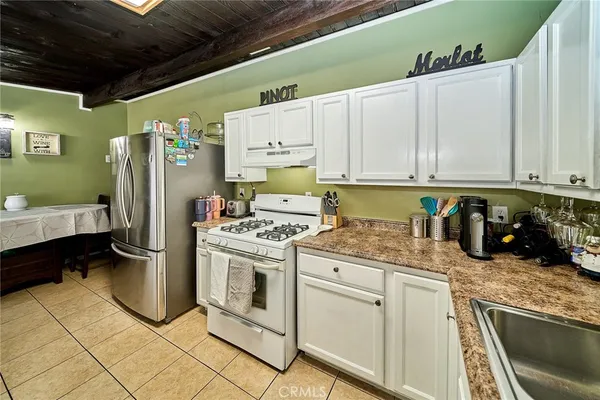 a kitchen with refrigerator and cabinets