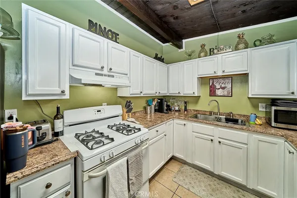 a kitchen with cabinets appliances a sink and a counter