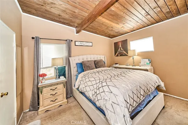 a bedroom with a large bed and a window