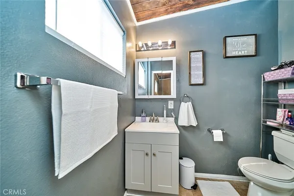 a bathroom with a sink toilet and mirror