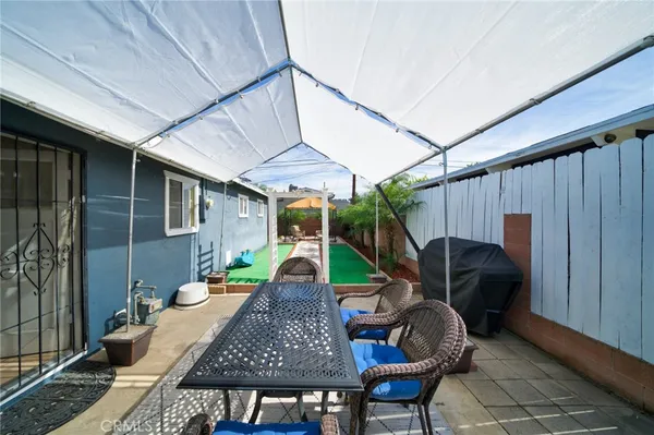 a view of a patio with table and chairs and potted plants