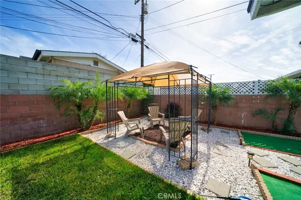 a view of a patio with table and chairs under an umbrella