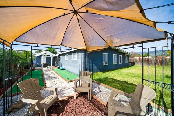 a view of backyard of house with seating space