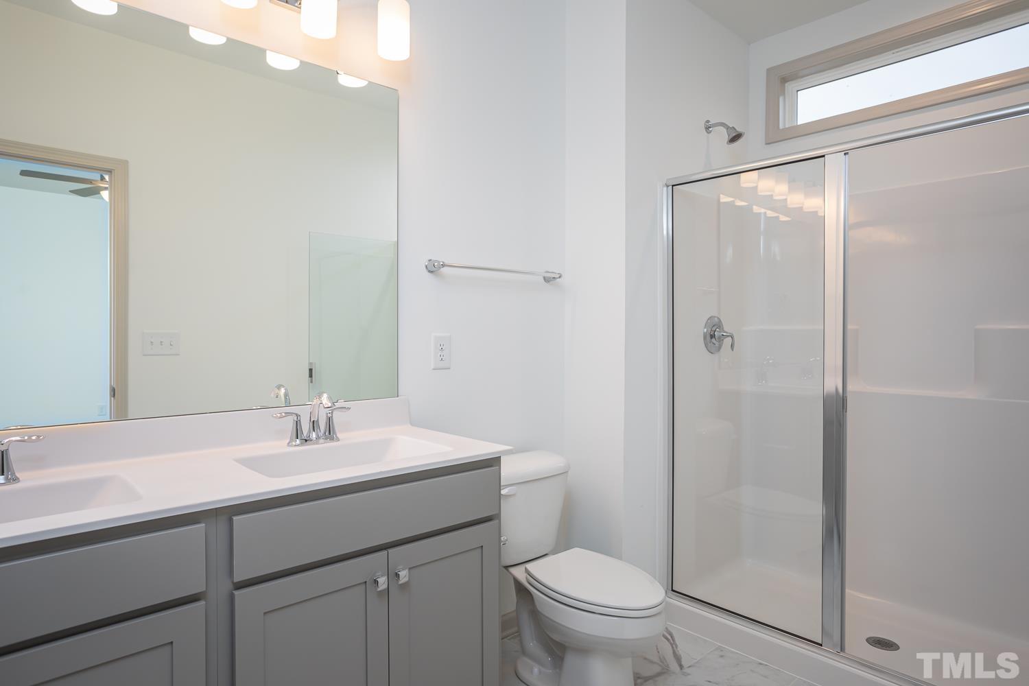 749 Hadstock Path Zebulon, NC 27597 - Photo 15 of 25 a bathroom with a sink a toilet and shower