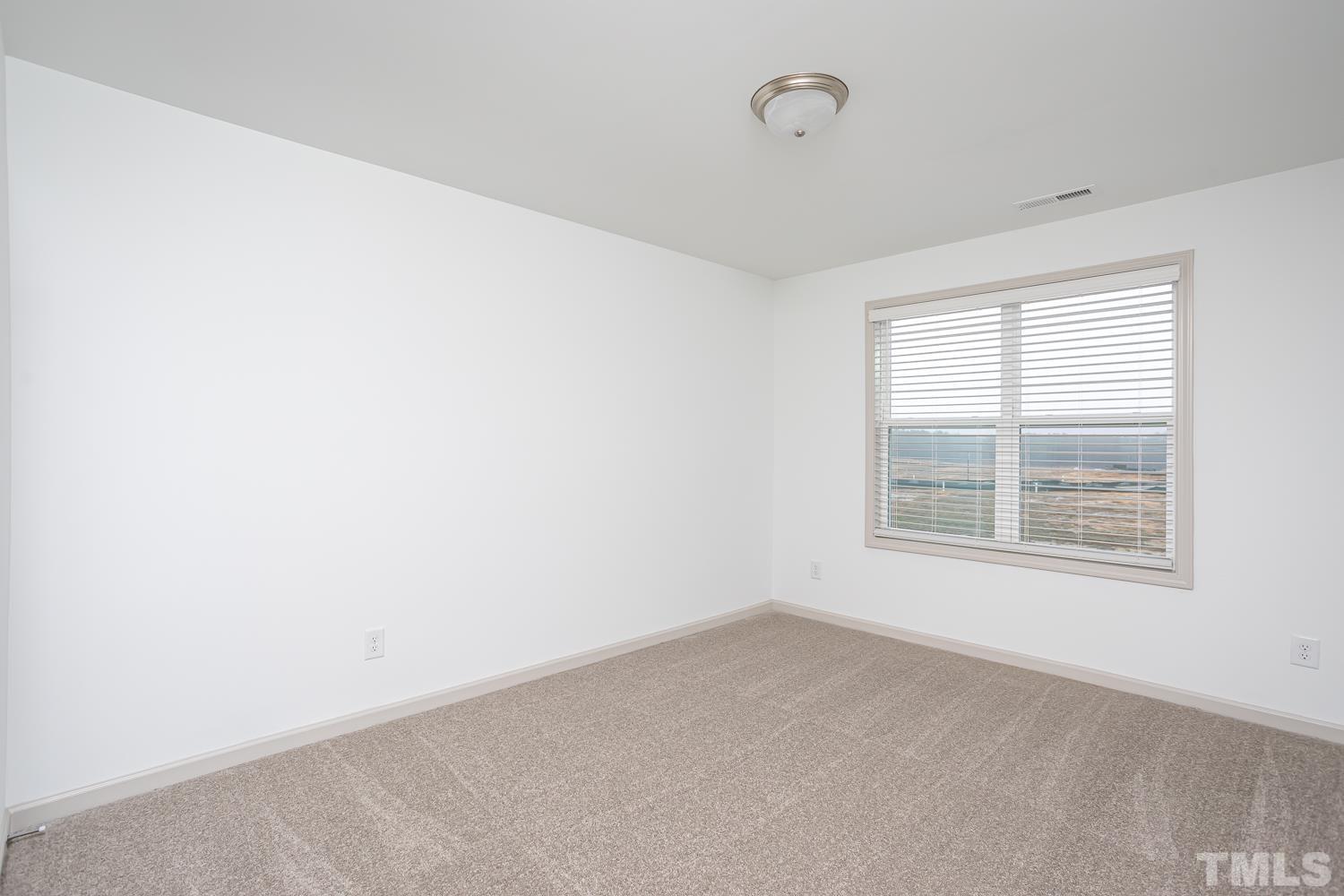 749 Hadstock Path Zebulon, NC 27597 - Photo 16 of 25 an empty room with a window