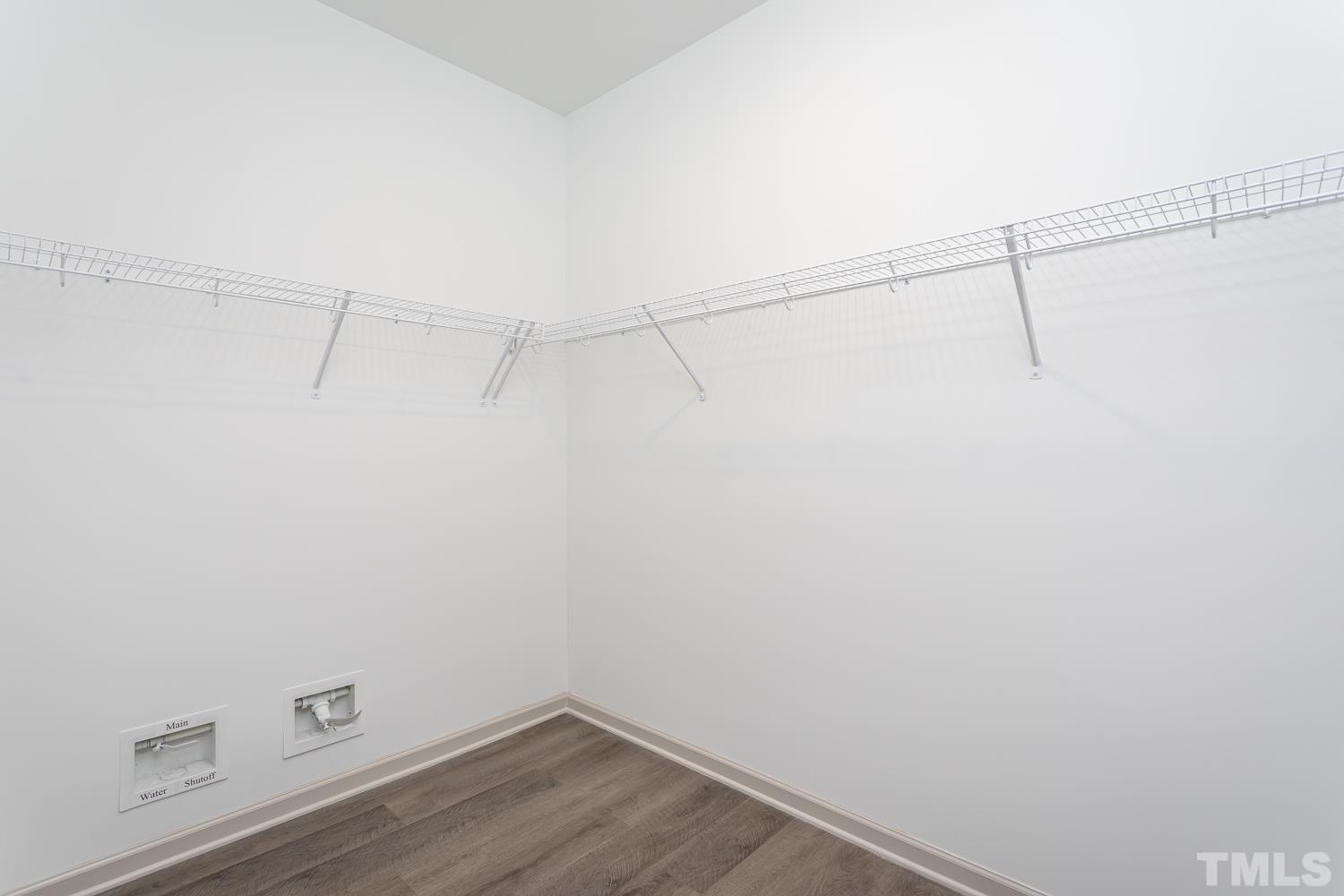 749 Hadstock Path Zebulon, NC 27597 - Photo 21 of 25 a view of a room with racks on the wall