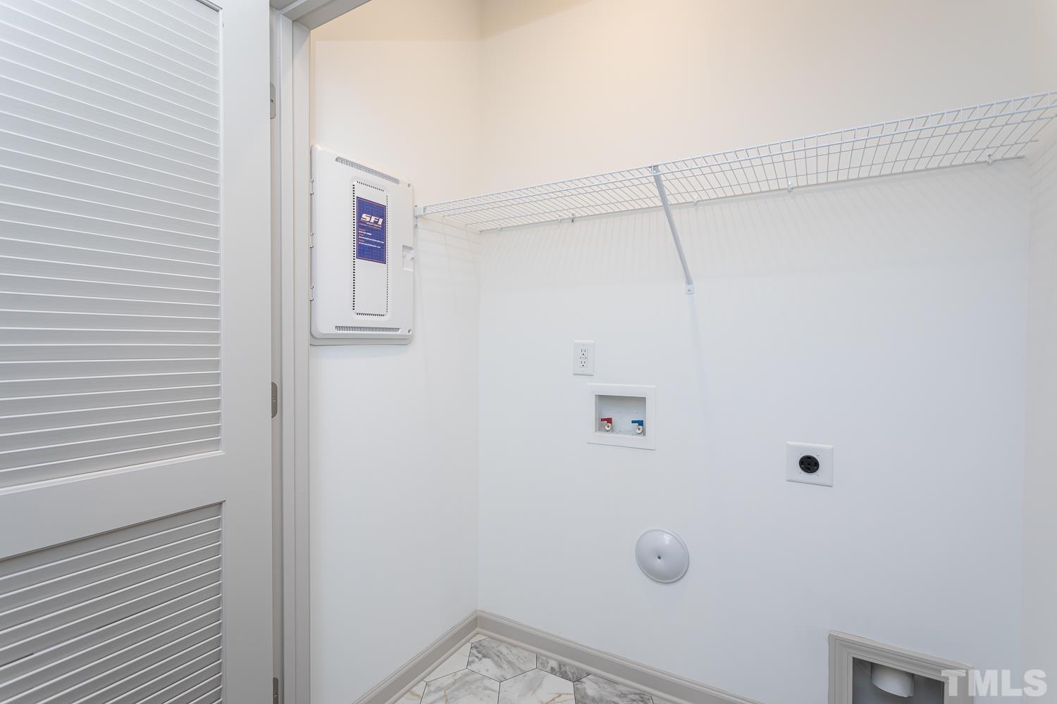 749 Hadstock Path Zebulon, NC 27597 - Photo 22 of 25 a view of a room with racks on the wall