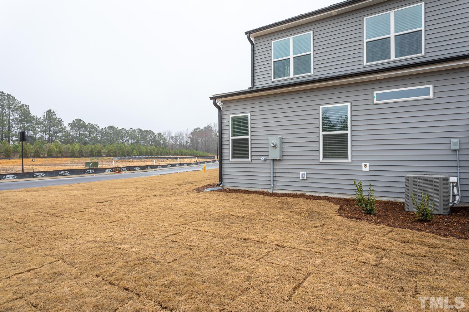 749 Hadstock Path Zebulon, NC 27597 - Photo 25 of 25 a view of a house with backyard and lake