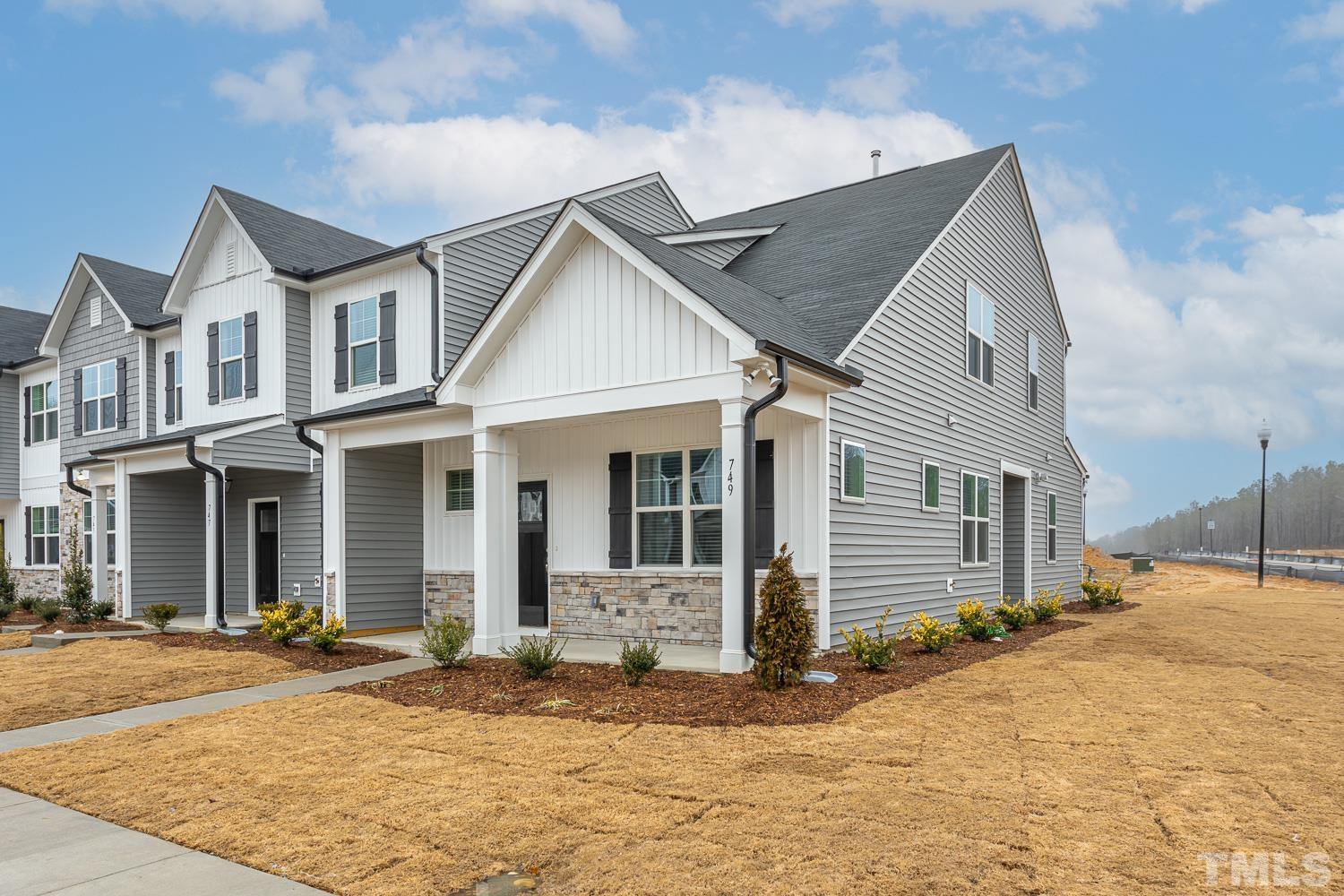 749 Hadstock Path Zebulon, NC 27597 - Photo 3 of 25 a view of a white house with large windows
