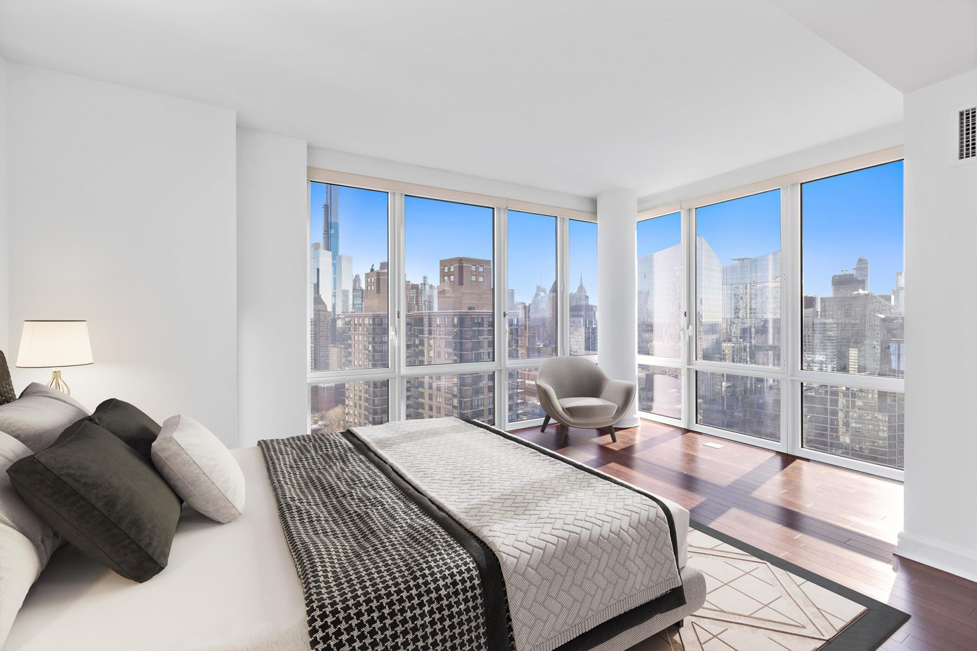 80 Riverside Boulevard, Unit 37B Manhattan, NY 10069 - Photo 1 of 22 a bedroom with a bed and glass window