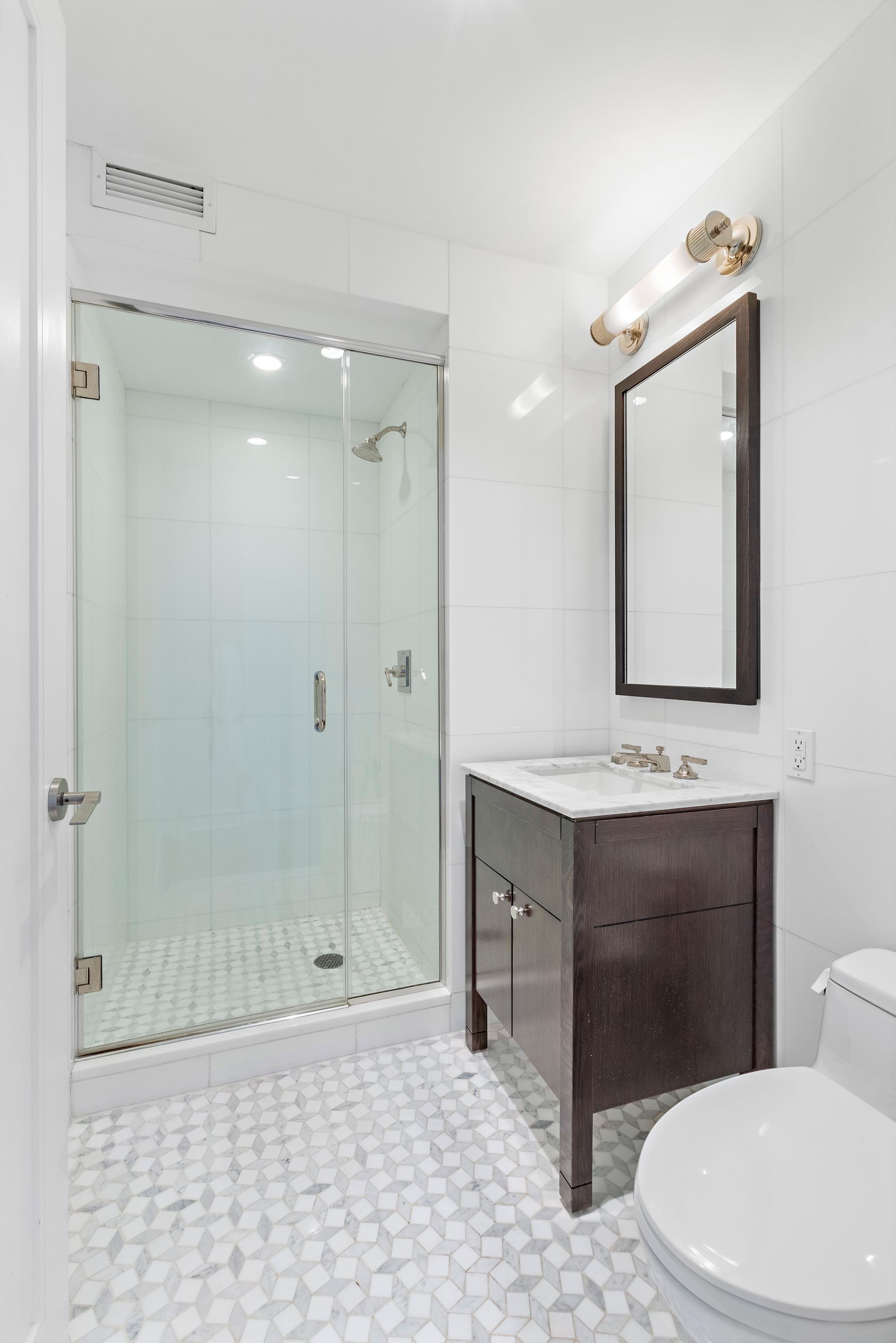 80 Riverside Boulevard, Unit 37B Manhattan, NY 10069 - Photo 11 of 22 a bathroom with a sink a toilet and shower