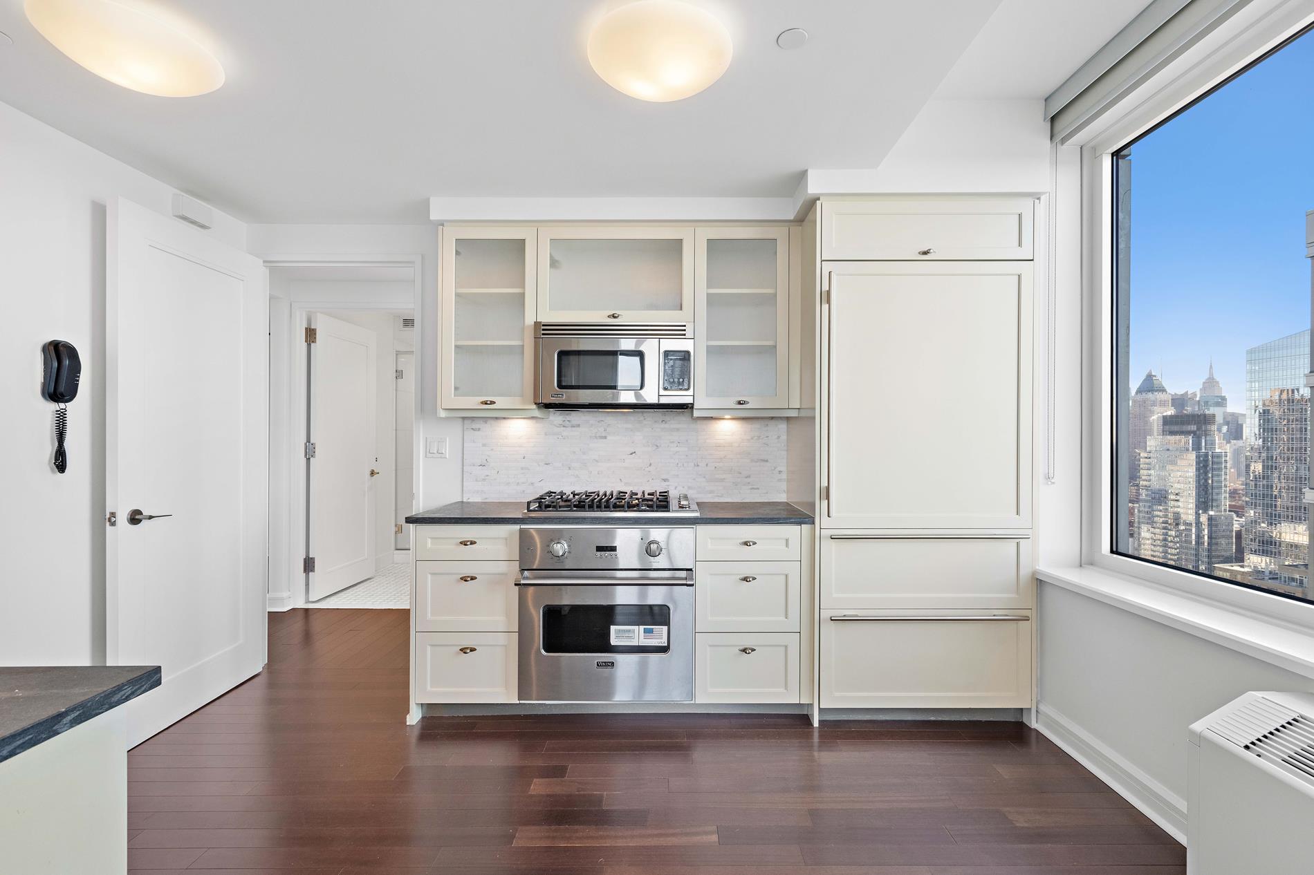80 Riverside Boulevard, Unit 37B Manhattan, NY 10069 - Photo 13 of 22 a kitchen with stainless steel appliances granite countertop a stove a sink and a refrigerator
