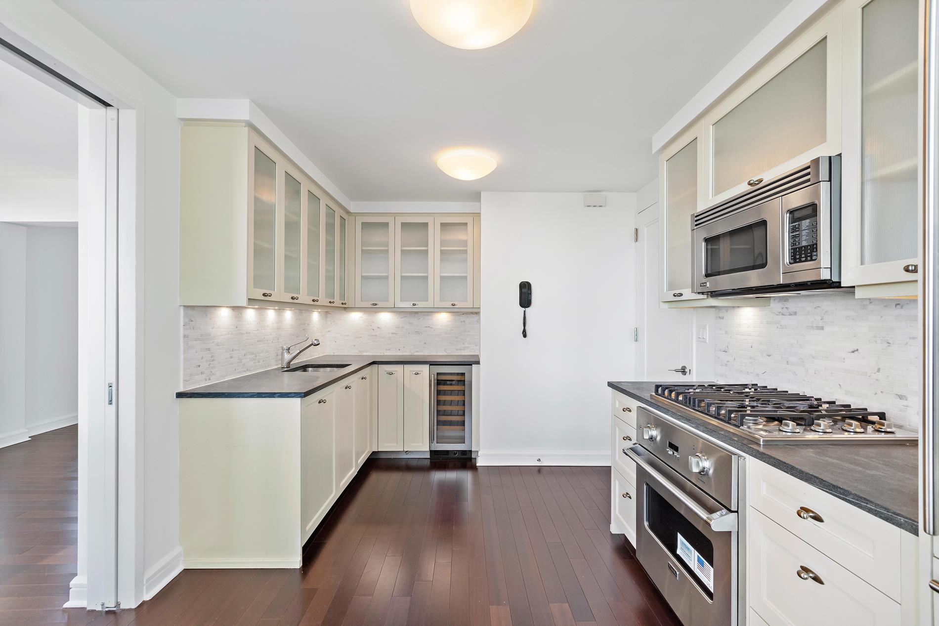 80 Riverside Boulevard, Unit 37B Manhattan, NY 10069 - Photo 14 of 22 a kitchen with stainless steel appliances granite countertop a stove and a refrigerator