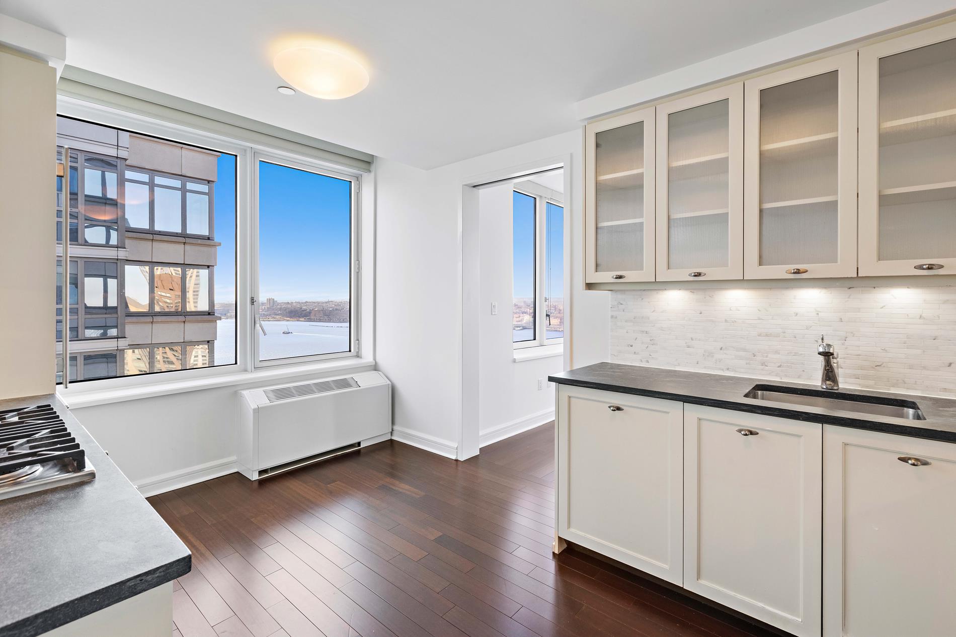 80 Riverside Boulevard, Unit 37B Manhattan, NY 10069 - Photo 15 of 22 a kitchen that has a sink and a stove