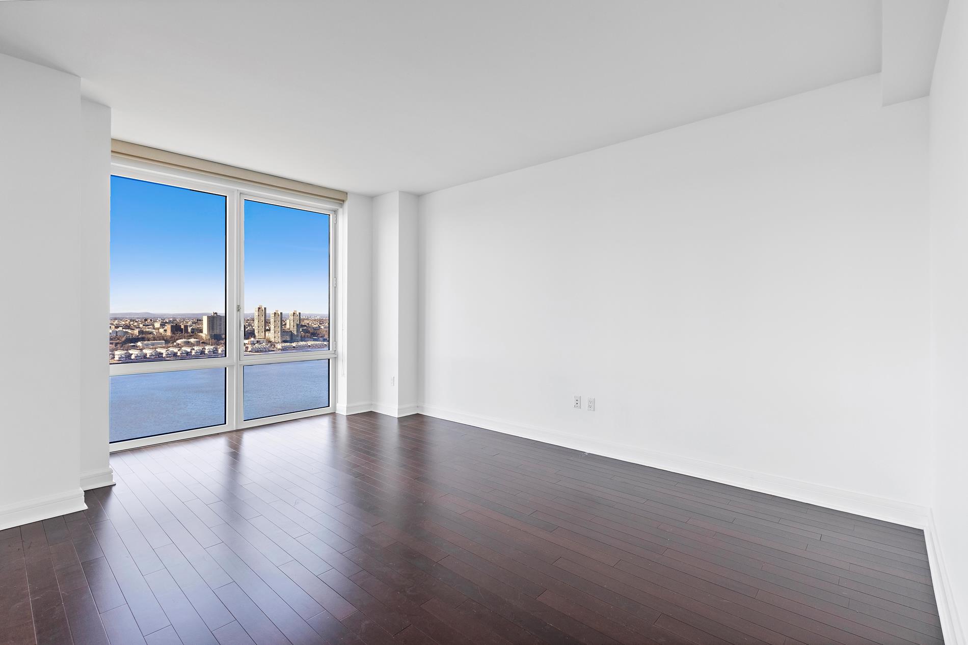 80 Riverside Boulevard, Unit 37B Manhattan, NY 10069 - Photo 19 of 22 a view of an empty room with wooden floor