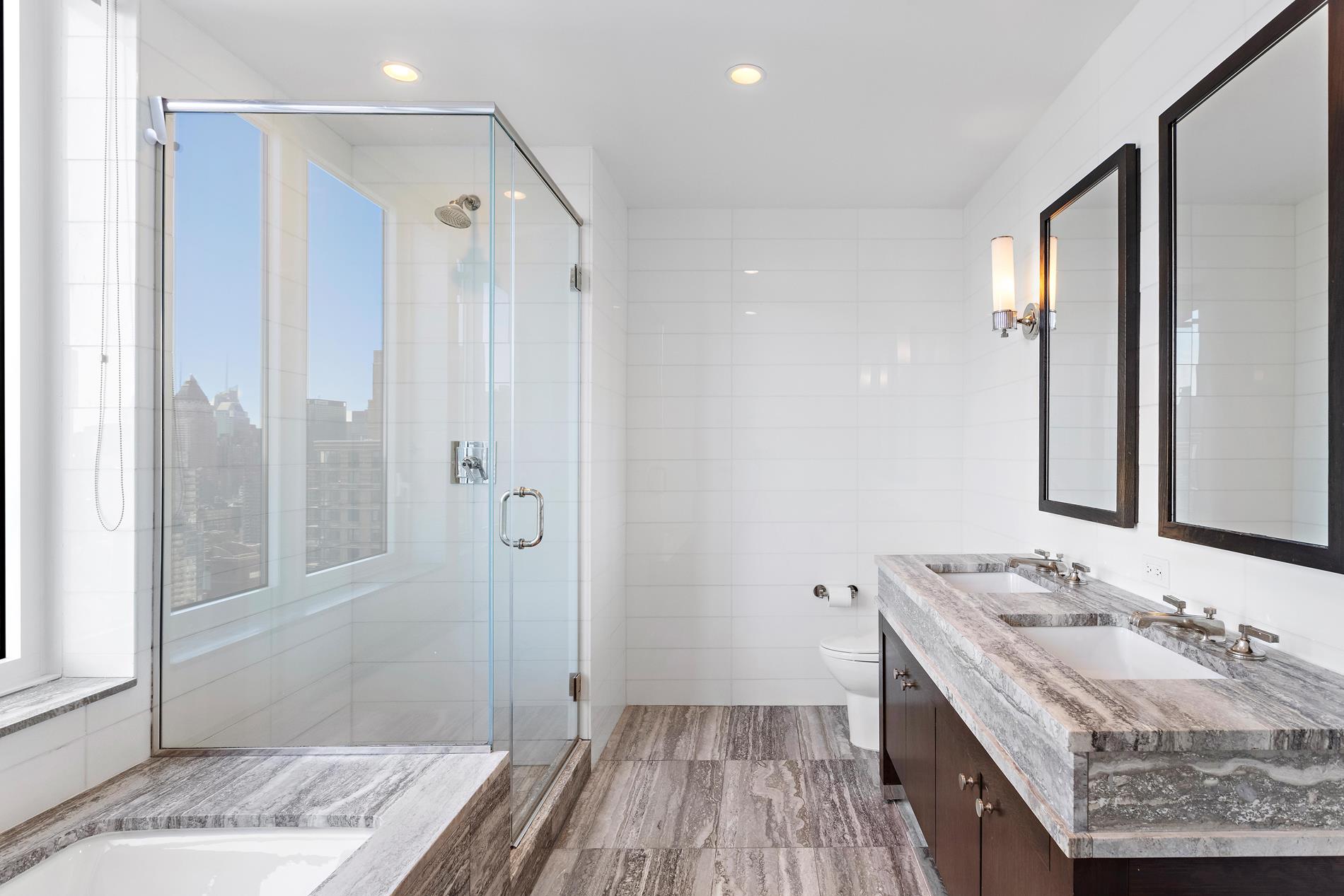 80 Riverside Boulevard, Unit 37B Manhattan, NY 10069 - Photo 8 of 22 a bathroom with a granite countertop sink a mirror and shower