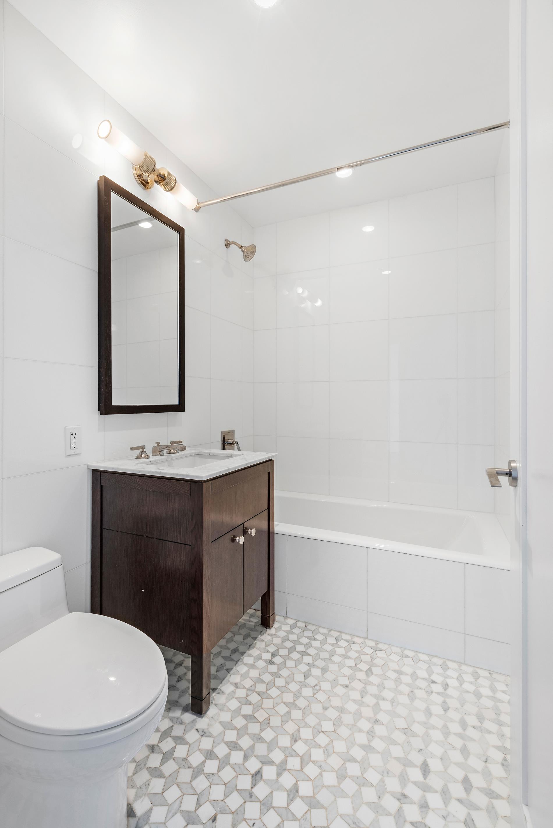 80 Riverside Boulevard, Unit 37B Manhattan, NY 10069 - Photo 9 of 22 a bathroom with a toilet sink and mirror