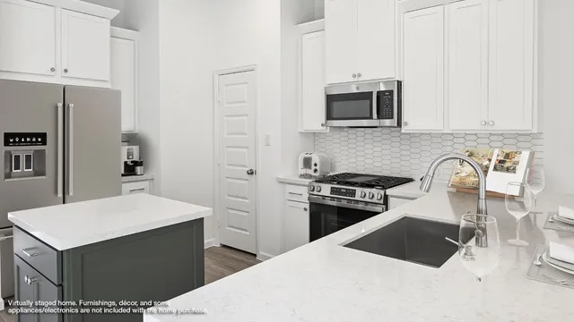 a kitchen with a stove a refrigerator and a sink