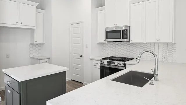 a kitchen with a stove and a microwave