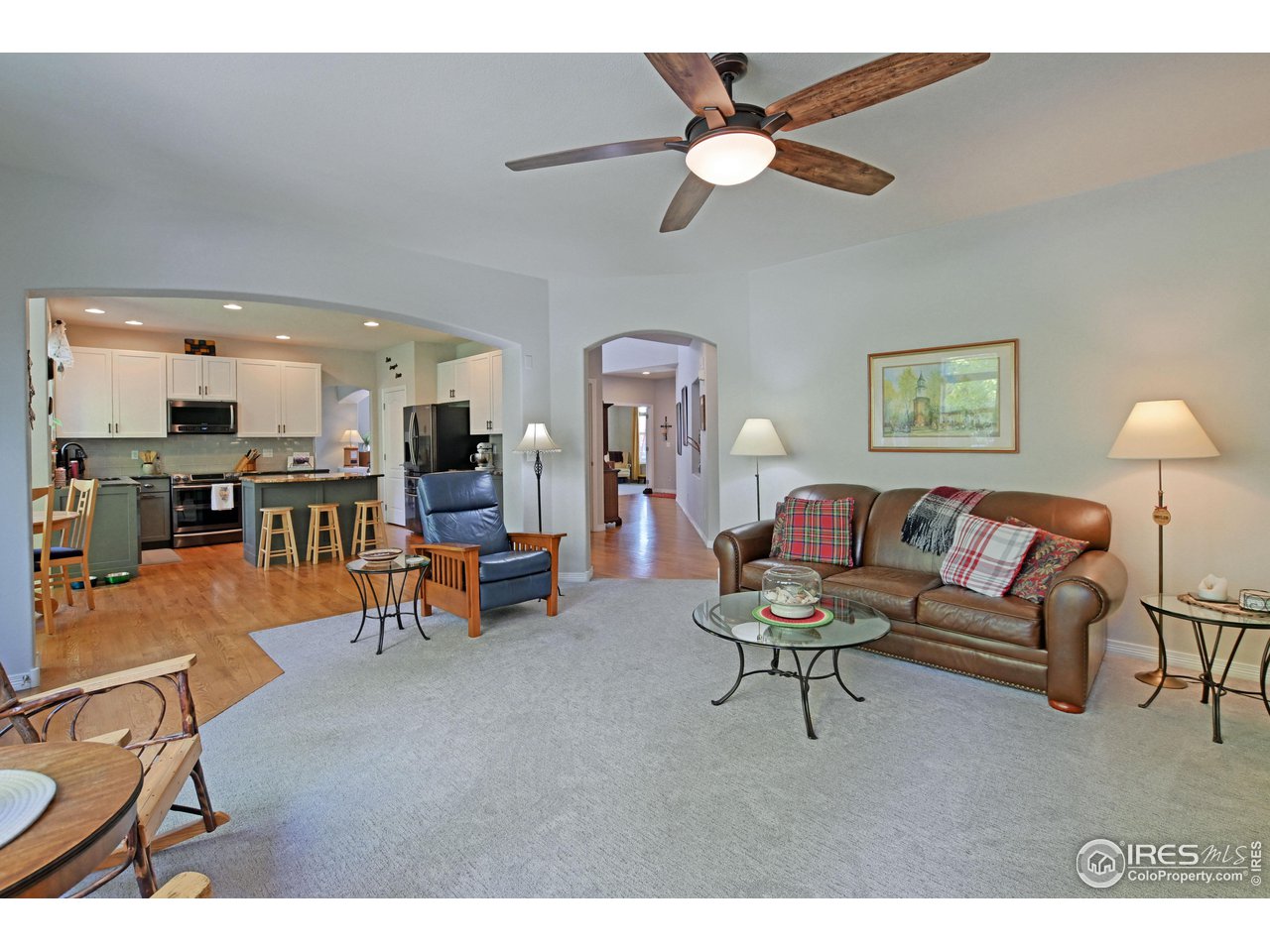8113 Northstar Drive Windsor, CO 80528 - Photo 11 of 40 a living room with furniture and kitchen view