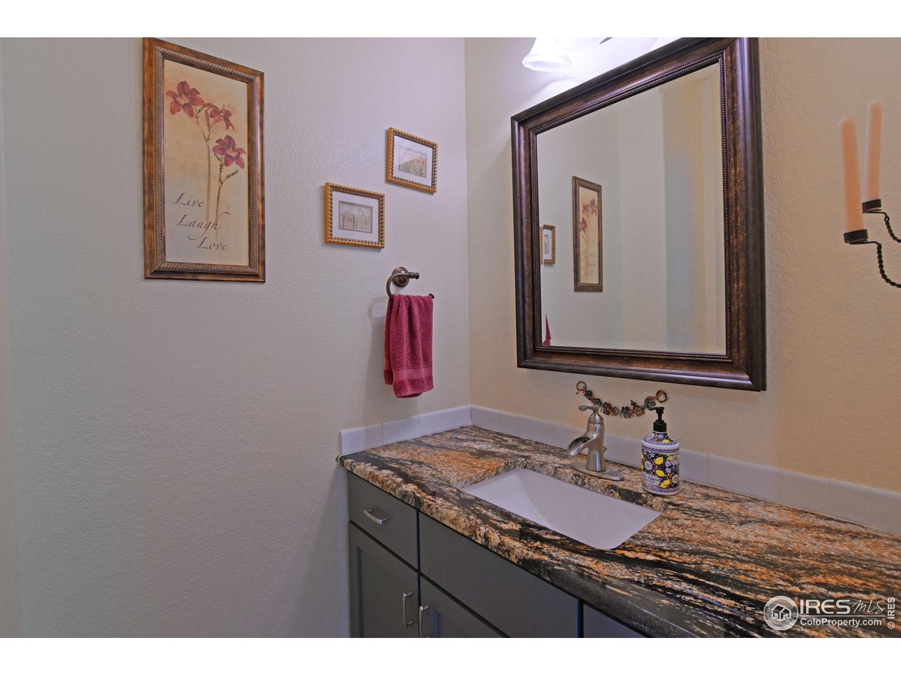 8113 Northstar Drive Windsor, CO 80528 - Photo 12 of 40 a bathroom with a sink vanity and mirror