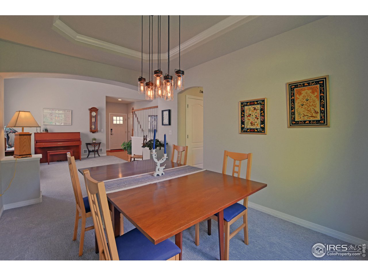 8113 Northstar Drive Windsor, CO 80528 - Photo 14 of 40 a view of a dining room with furniture and a chandelier