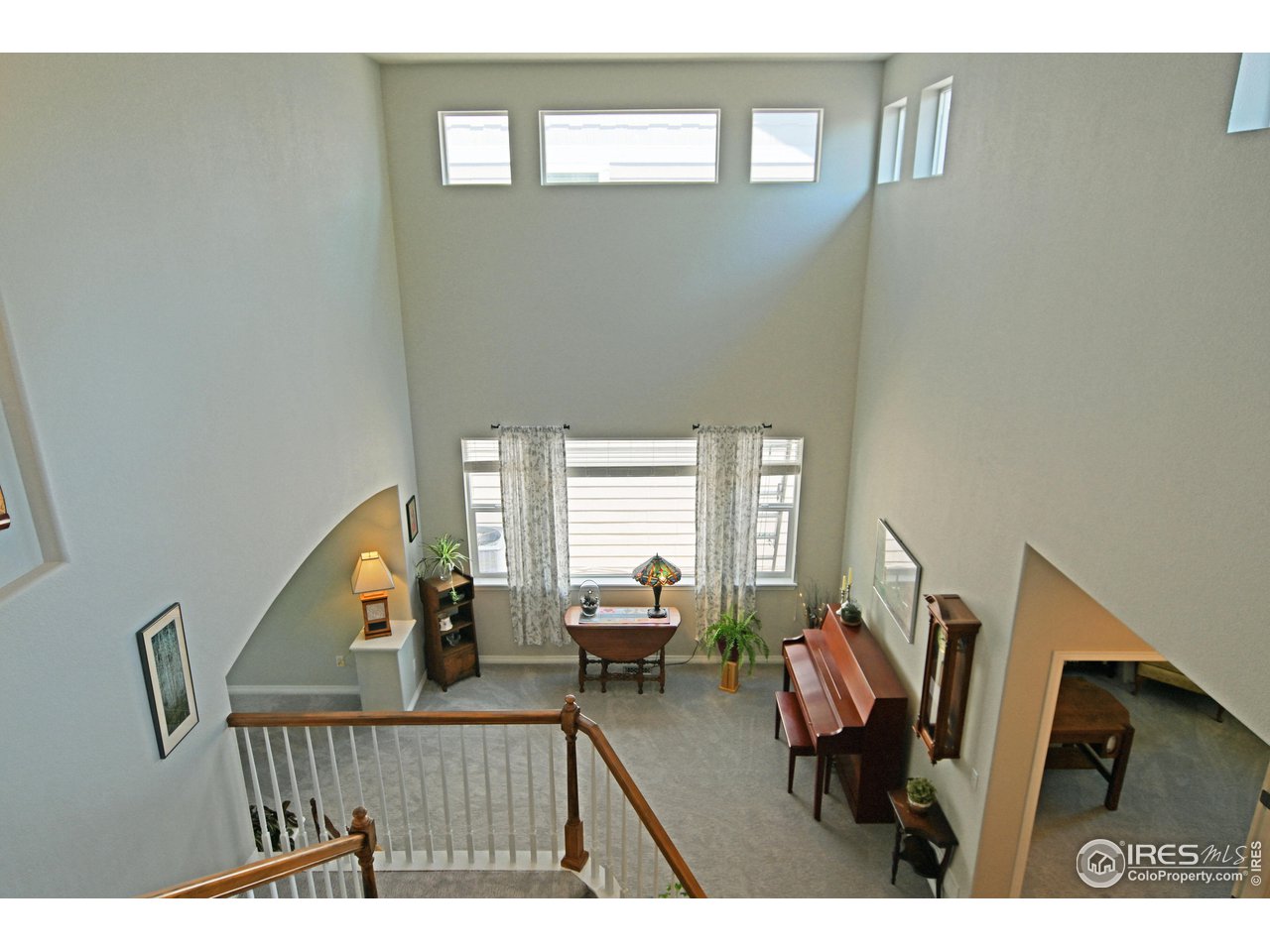 8113 Northstar Drive Windsor, CO 80528 - Photo 16 of 40 a balcony view with chairs and wooden floor