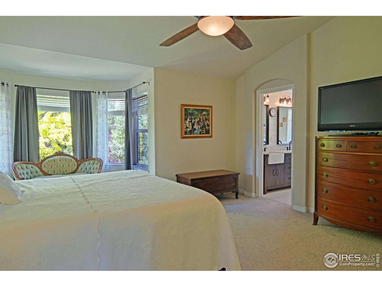 8113 Northstar Drive Windsor, CO 80528 - Photo 19 of 40 a bedroom with a bed and a flat screen tv