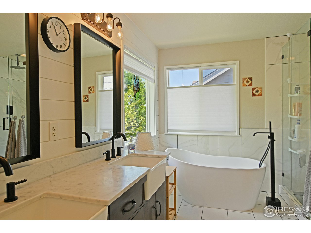 8113 Northstar Drive Windsor, CO 80528 - Photo 20 of 40 a bathroom with a sink mirror and a bathtub