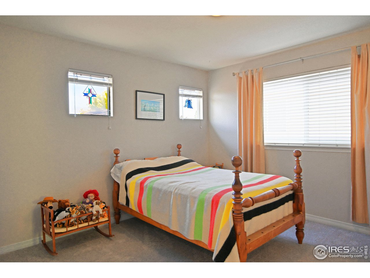 8113 Northstar Drive Windsor, CO 80528 - Photo 24 of 40 a bedroom with a bed and a window