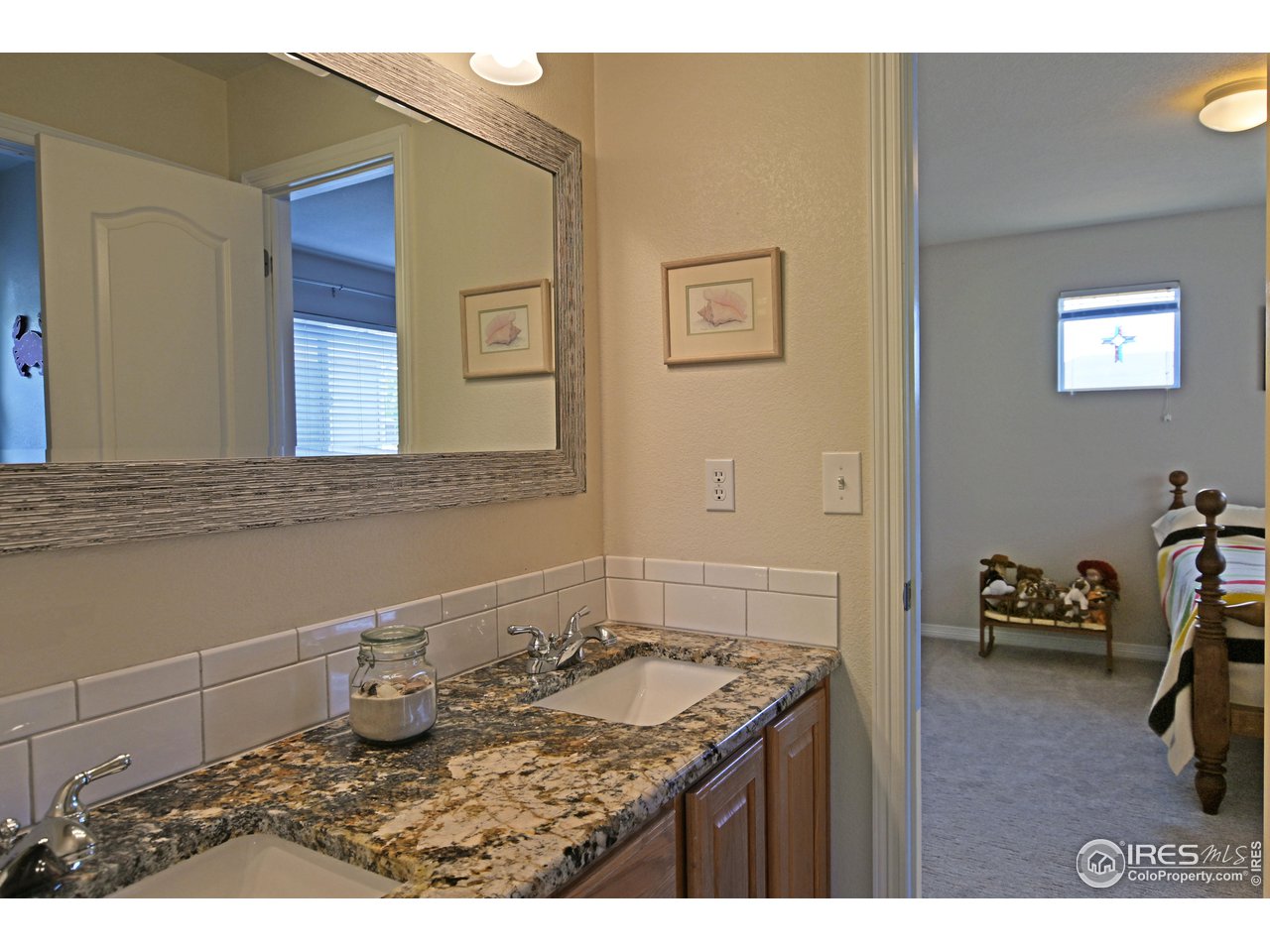 8113 Northstar Drive Windsor, CO 80528 - Photo 26 of 40 a bathroom with a sink and a mirror
