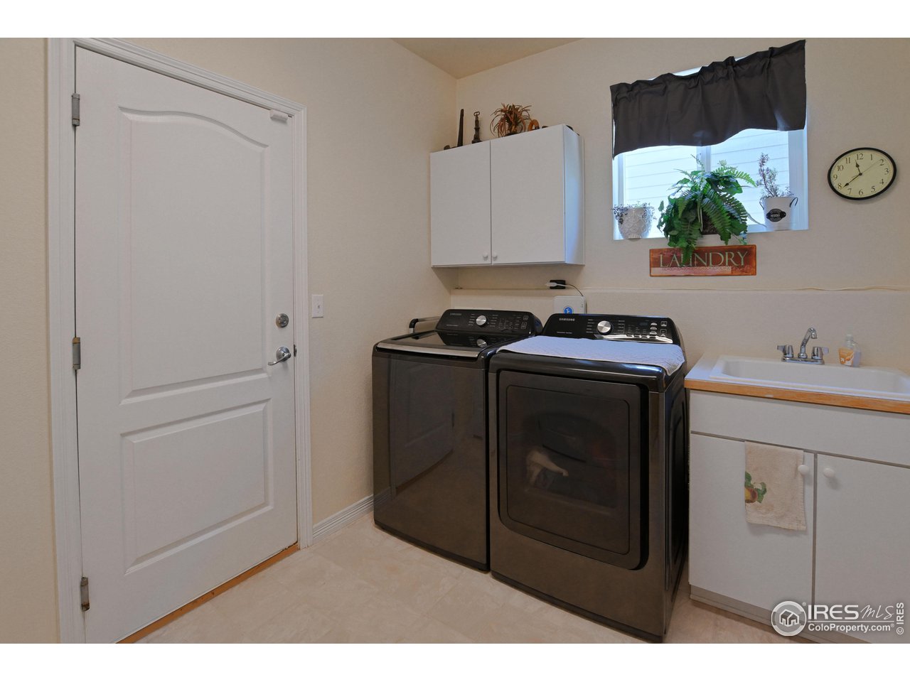 8113 Northstar Drive Windsor, CO 80528 - Photo 33 of 40 a utility room with sink dryer and washer