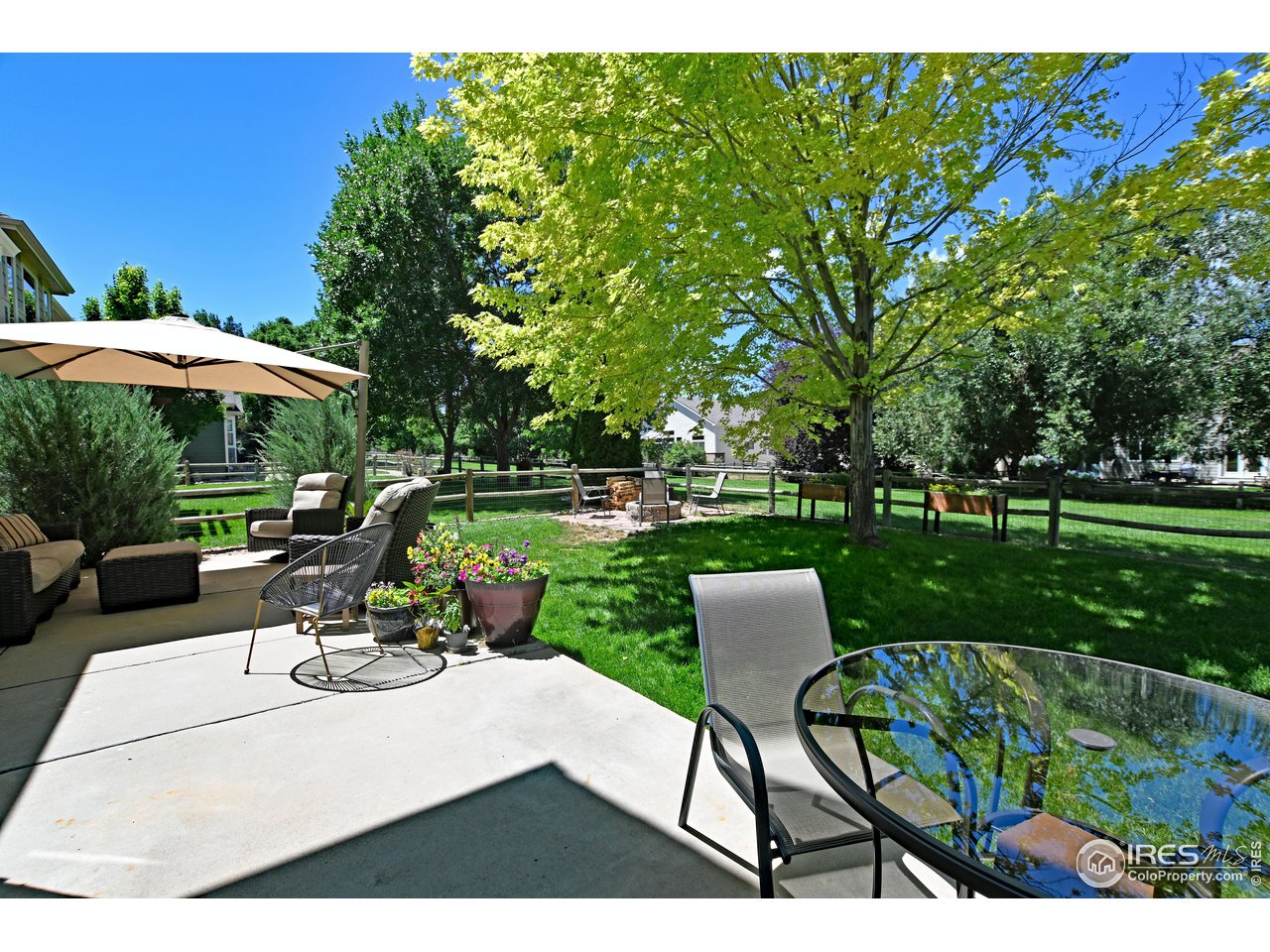 8113 Northstar Drive Windsor, CO 80528 - Photo 38 of 40 a view of a table and chairs under an umbrella