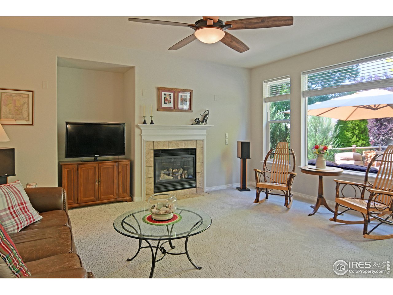 8113 Northstar Drive Windsor, CO 80528 - Photo 9 of 40 a living room with furniture a flat screen tv and a fireplace