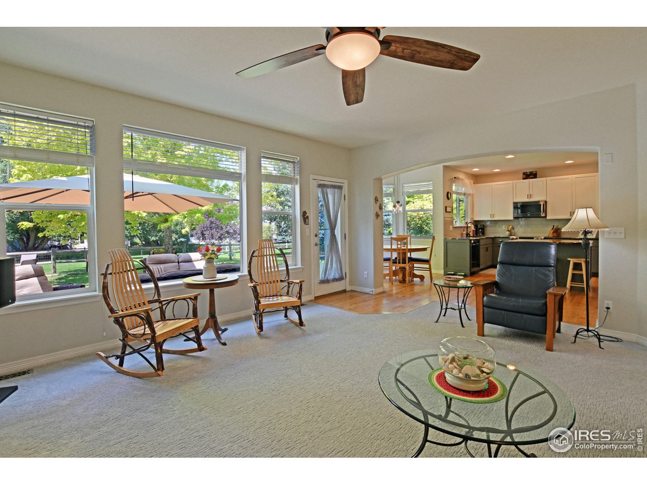 8113 Northstar Drive Windsor, CO 80528 - Photo 10 of 40 a living room with furniture a rug and a large window