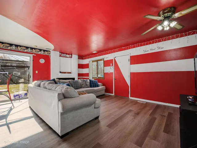 a living room with furniture and a ceiling fan