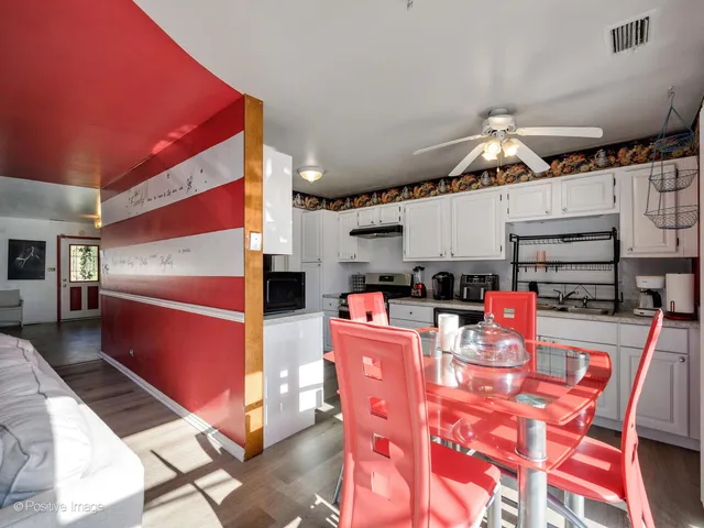 a kitchen with stainless steel appliances kitchen island granite countertop a sink and cabinets