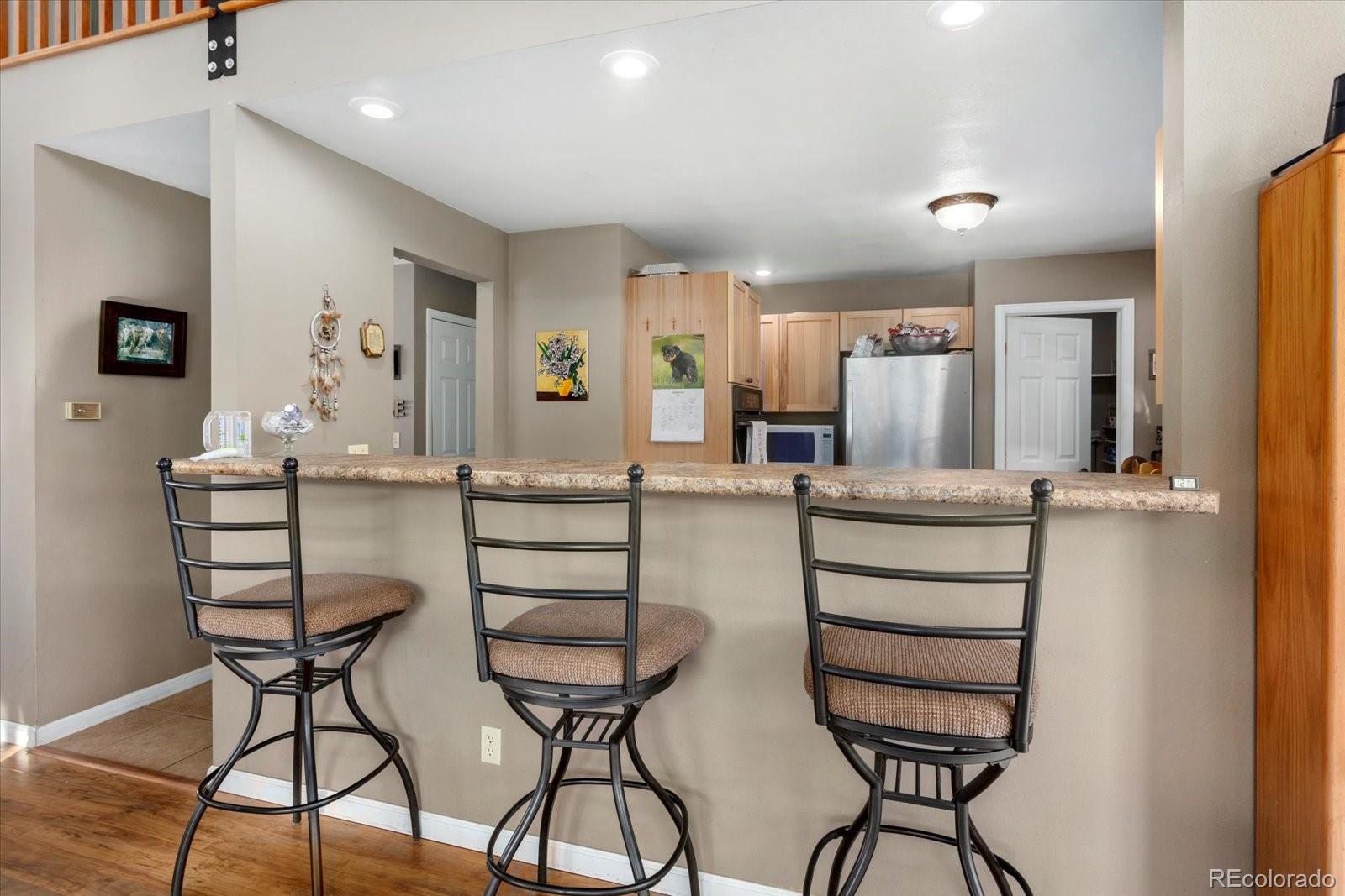 402 Trailridge Road Coaldale, CO 81222 - Photo 12 of 50 a kitchen with stainless steel appliances kitchen island granite countertop a table and chairs in it