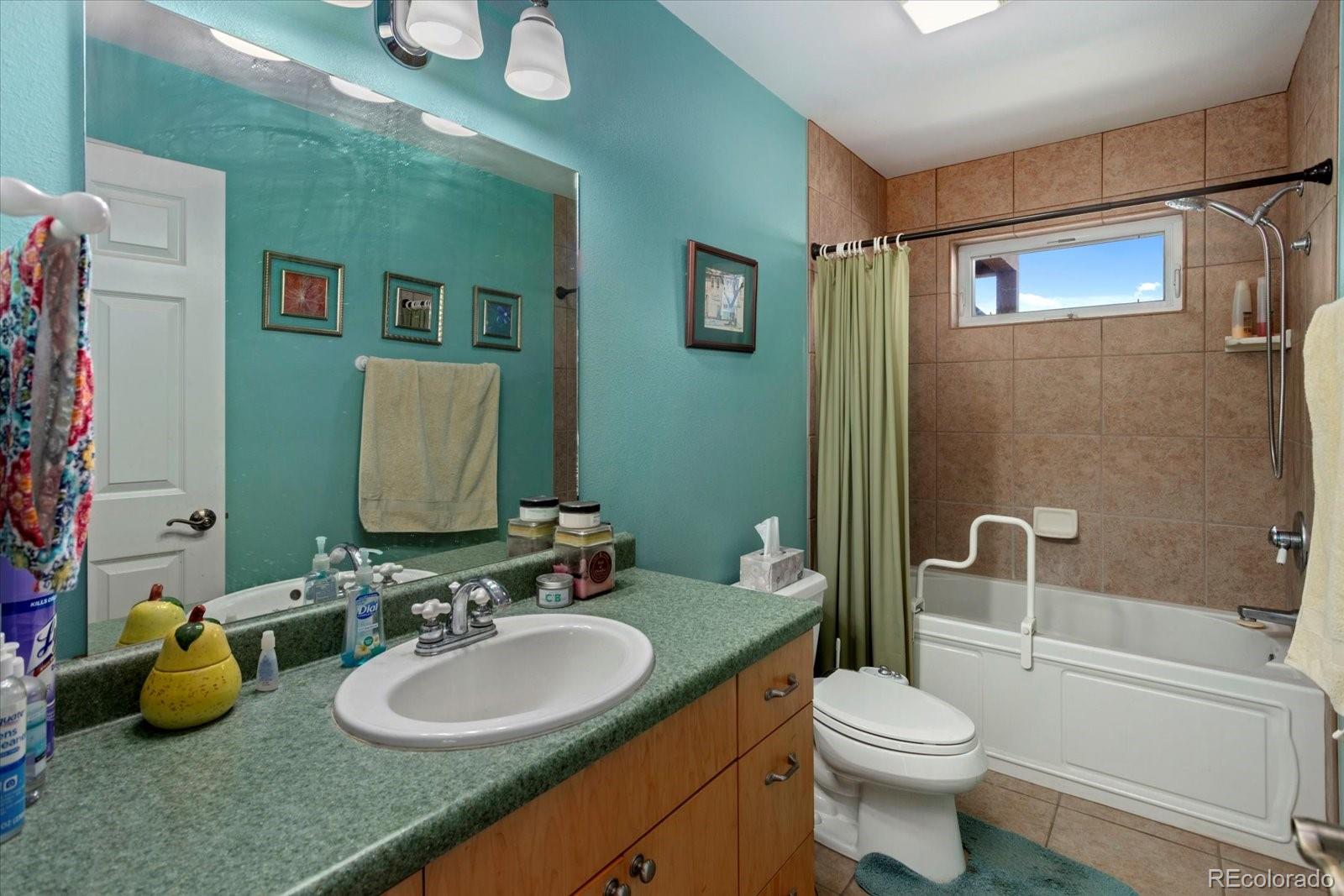 402 Trailridge Road Coaldale, CO 81222 - Photo 28 of 50 a bathroom with a granite countertop sink mirror vanity and toilet