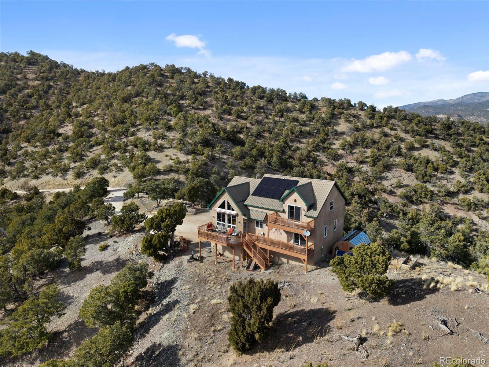 402 Trailridge Road Coaldale, CO 81222 - Photo 43 of 50 an aerial view of a house with a yard and mountain view in back
